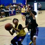 Young basketball players competing intensely on the court.