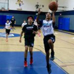 Young basketball players competing in an indoor game.