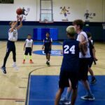 Youth basketball game in action with a player shooting.
