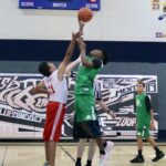 Two basketball players competing for the ball during a game.