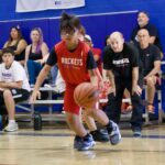 Young basketball player dribbling during a game.