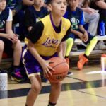 Young basketball player preparing to shoot during a game.