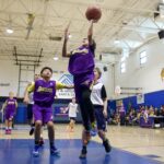 Youth basketball players compete in a gym game.