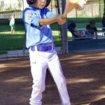 Young baseball player preparing to swing the bat on the field.
