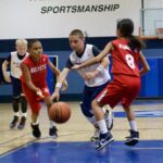 Youth basketball players competing intensely on the court.