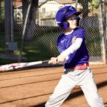 Young baseball player preparing to hit the ball during a game.