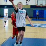 A young basketball player attempts a shot during a game.
