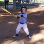 Young child ready to bat in a baseball game.