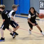 Youth basketball players in action during a game.