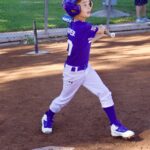 Young baseball player pitching during a game.