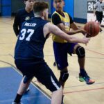 Two basketball players in action during a game.