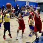 Young basketball players in action during a game.