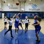 Youth basketball game in action on an indoor court.