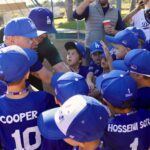 Youth baseball team celebrates a moment together on the field.