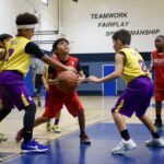 Youth basketball players competing intensely on the court.