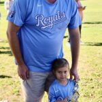 A man and a child in matching Royals baseball shirts.