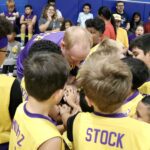Young basketball team huddled together in a group cheer.